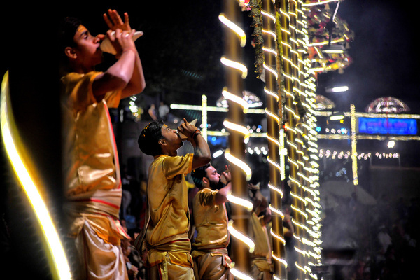 Hindu priests perform "Evening Aarati" prayers at Assi Ghat, during the Ganga Aarti, a traditional and old Hindu ritual honoring the Ganges River which is held at the Banks of the river.