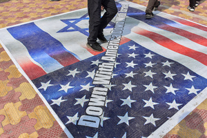 Kashmiri Shiite Muslim protesters walk on the U.S. and Israeli flags during a protest rally against the killing of the Iranian Supreme Leader, Ayatollah Ali Khamenei, in Budgam, about 25kms from Srinagar. Protests continue across the Kashmir valley over the killing of Iran's Supreme Leader Ayatollah Ali Khamenei in a coordinated US-Israeli airstrike on Tehran. Strict restrictions remained imposed in many areas of Kashmir for the fifth consecutive day.