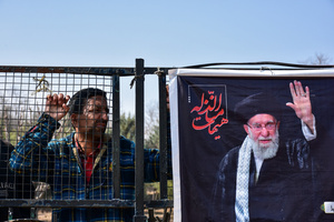A Kashmiri Shiite Muslim protesters looks on as he stands near a photograph of the deceased Iranian Supreme Leader, Ayatollah Ali Khamenei, during a protest rally against the U.S. and Israel in Budgam, about 25kms from Srinagar. Protests continue across the Kashmir valley over the killing of Iran's Supreme Leader Ayatollah Ali Khamenei in a coordinated US-Israeli airstrike on Tehran. Strict restrictions remained imposed in many areas of Kashmir for the fifth consecutive day.