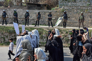 Paramilitary troopers stand alert as Kashmiri Shiite Muslim protesters shout slogans during a protest rally against the killing of the Iranian Supreme Leader, Ayatollah Ali Khamenei, in Budgam, about 25kms from Srinagar. Protests continue across the Kashmir valley over the killing of Iran's Supreme Leader Ayatollah Ali Khamenei in a coordinated US-Israeli airstrike on Tehran. Strict restrictions remained imposed in many areas of Kashmir for the fifth consecutive day.