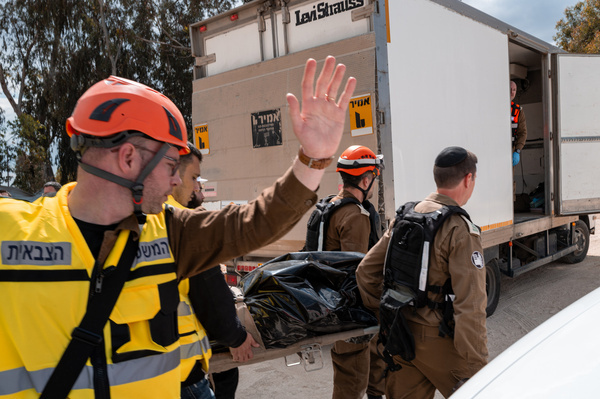 (EDITORS NOTE: Image depicts death) The body of one of the victims seen removed from the missile impact site by Israeli rescue personnel and members of ZAKA. Two men were killed after a ballistic missile carrying a cluster munition warhead struck a construction site during a missile barrage launched from Iran. The attacks come amid escalating regional tensions following joint U.S.– Israeli strikes on Iranian targets in late February.