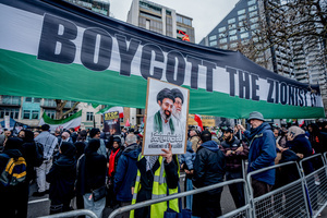 Huge pro-Iranian regime banner calling for the boycotting of Israel. Many thousands congregated in Central London in an international demonstration of support for Palestinian rights. They were separated by Police from pro-Israeli and anti-Iranian-regime counter-protestors who met on the opposite side of the River Thames after the rally was banned from marching by the Home Secretary Shabana Mahmood. Rapper Bob Vylan spoke at the rally and is currently being investigated for chanting “Death to the IDF”.