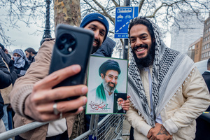 Rapper Bob Vylan poses with portraits of the murdered Ayatollah Ali Khamenei following his speech in which he chanted "Death to the IDF" in front of a crowd of thousands in London. Many thousands congregated in Central London in an international demonstration of support for Palestinian rights. They were separated by Police from pro-Israeli and anti-Iranian-regime counter-protestors who met on the opposite side of the River Thames after the rally was banned from marching by the Home Secretary Shabana Mahmood. Rapper Bob Vylan spoke at the rally and is currently being investigated for chanting “Death to the IDF”.
