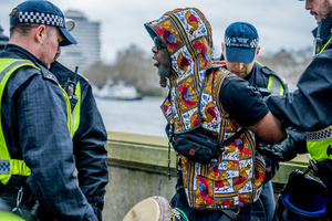 A pro-Palestinian musician activist is arrested under Section 14 of the Public Order Act 1986 for not dispersing after the rally. Many thousands congregated in Central London in an international demonstration of support for Palestinian rights. They were separated by Police from pro-Israeli and anti-Iranian-regime counter-protestors who met on the opposite side of the River Thames after the rally was banned from marching by the Home Secretary Shabana Mahmood. Rapper Bob Vylan spoke at the rally and is currently being investigated for chanting “Death to the IDF”.