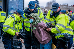A pro-Palestinian protestor is arrested by police for refusing to remove a face covering. Many thousands congregated in Central London in an international demonstration of support for Palestinian rights. They were separated by Police from pro-Israeli and anti-Iranian-regime counter-protestors who met on the opposite side of the River Thames after the rally was banned from marching by the Home Secretary Shabana Mahmood. Rapper Bob Vylan spoke at the rally and is currently being investigated for chanting “Death to the IDF”.
