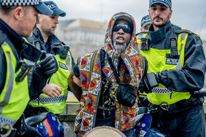 A pro-Palestinian musician activist is arrested under Section 14 of the Public Order Act 1986 for not dispersing after the rally. Many thousands congregated in Central London in an international demonstration of support for Palestinian rights. They were separated by Police from pro-Israeli and anti-Iranian-regime counter-protestors who met on the opposite side of the River Thames after the rally was banned from marching by the Home Secretary Shabana Mahmood. Rapper Bob Vylan spoke at the rally and is currently being investigated for chanting “Death to the IDF”.