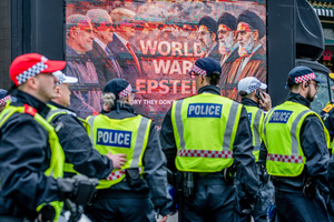 Police officers file past a display depicting US-Israeli attack on Iran as the start of World War 3. Many thousands congregated in Central London in an international demonstration of support for Palestinian rights. They were separated by Police from pro-Israeli and anti-Iranian-regime counter-protestors who met on the opposite side of the River Thames after the rally was banned from marching by the Home Secretary Shabana Mahmood. Rapper Bob Vylan spoke at the rally and is currently being investigated for chanting “Death to the IDF”.