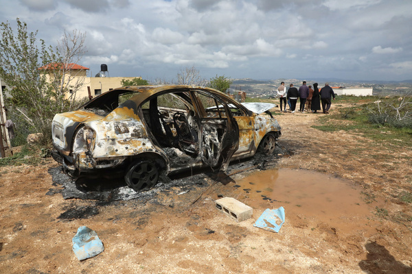 Palestinians inspect a burned vehicle after an attack by Jewish settlers on farmers' property in the village of Fandaqamiya. The attack followed the killing of a Jewish shepherd from the settlement of Elon Moreh. Violence is escalating between Jewish settlers and Palestinians in areas under the control of the Palestinian Authority headed by Mahmoud Abbas whose territory in the West Bank Israel seeks to annex.