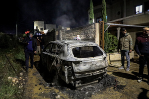 People inspect a burned car following an attack by Jewish settlers on the village of Deir al-Hatab, east of Nablus in the West Bank. Israeli settlers from Elon Moreh carried out attacks in several Palestinian villages, including Deir al-Hatab, following the funeral of 18-year-old Yehuda Sherman. Israeli police said Sherman died in a car collision with a Palestinian vehicle and are investigating whether it was deliberate or an accident. After the funeral, settlers set fire to homes and vehicles and spray-painted “revenge” in Hebrew, leaving at least 10 Palestinians injured, including one man shot and a woman treated for smoke inhalation.
