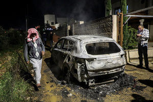 People inspect a burned car following an attack by Jewish settlers on the village of Deir al-Hatab, east of Nablus in the West Bank. Israeli settlers from Elon Moreh carried out attacks in several Palestinian villages, including Deir al-Hatab, following the funeral of 18-year-old Yehuda Sherman. Israeli police said Sherman died in a car collision with a Palestinian vehicle and are investigating whether it was deliberate or an accident. After the funeral, settlers set fire to homes and vehicles and spray-painted “revenge” in Hebrew, leaving at least 10 Palestinians injured, including one man shot and a woman treated for smoke inhalation.