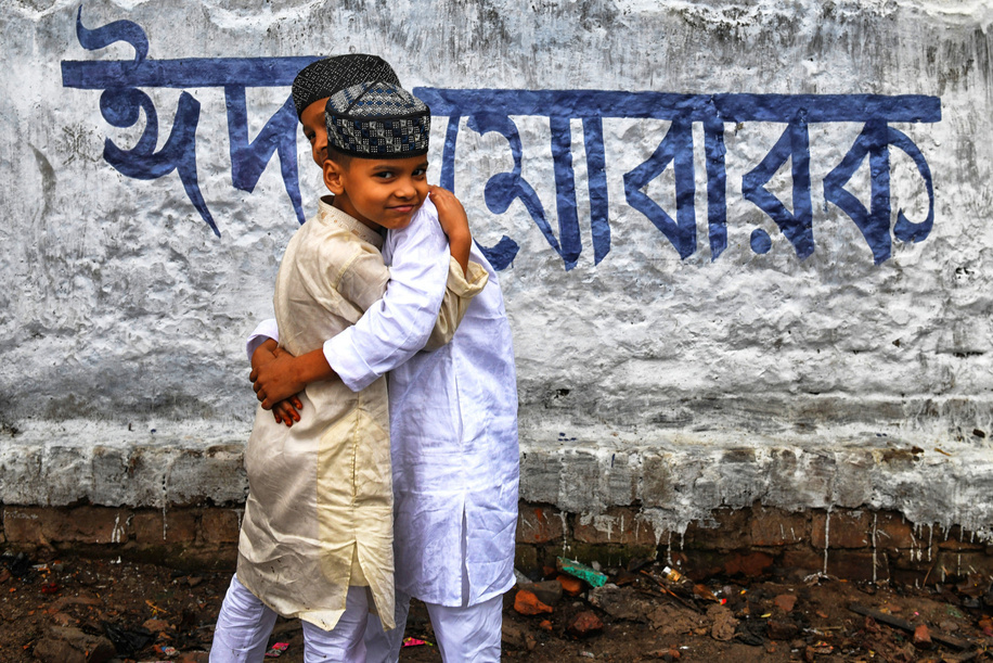 Little children hug each other after the namaz prayer of Eid-ul-Fitr at Kolkata.