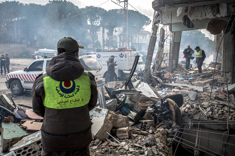 A man wearing the logo of the Hezbollah-linked Islamic Health Organisation stands in the remains of a health centre in Bourj Qalaway, following an Israeli attack. At least 850 people in Lebanon have been killed since Israel and Hezbollah returned to all-out war, including 32 healthcare workers, according to Lebanon's Ministry of Health.