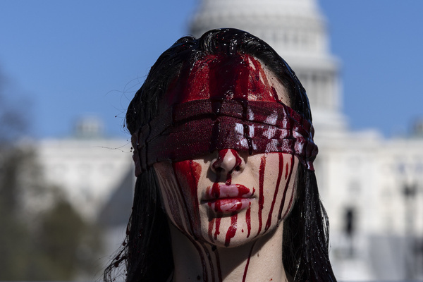 A demonstrator dressed as Lady Justice, with fake blood on her face and body, stands in front of the US Capitol during a No Kings protest organized by Remove the Regime on the National Mall. The rally marks the third nationwide No Kings protest held in opposition to the administration of Donald Trump.