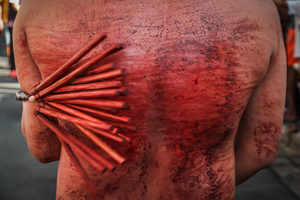 A devotee whip his back using bamboo stick while walking in the street as part of their self-flagellation on April 3, 2026, as an act of symbolic participation in the suffering of Jesus Christ. The Catholic Church maintains that physical sacrifice is unnecessary for the forgiveness of sins, many local flagellants continue the grueling practice as a public display of faith, endurance, and communal identity.