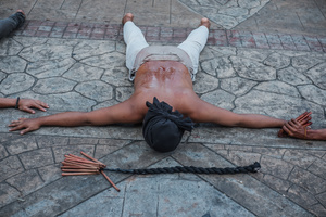A devotee seen laying down in the street as part of self-flagellation on April 3, 2026, as an act of symbolic participation in the suffering of Jesus Christ. The Catholic Church maintains that physical sacrifice is unnecessary for the forgiveness of sins, many local flagellants continue the grueling practice as a public display of faith, endurance, and communal identity.