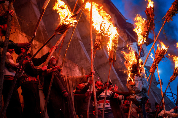 Kashmiri Muslims hold lit torches outside the cave shrine of Sakhi Zain-ud-din Wali, a Sufi saint, during an annual torch festival in Aishmuqam, 75 km (47 miles) south of Srinagar. Thousands of Muslim villagers in Indian-administered Kashmir gathered at a 15th-century Sufi saint's hilltop shrine for the annual torch festival, also known as the Zool Festival. Devotees lit wooden torches to honour the revered saint, marking the end of winter and the beginning of the paddy sowing season. Many believe this traditional torch festival commemorates the saint's victory over a demon that once terrorized local villagers. Flames illuminated the forested hillside as people paid obeisance at the mausoleum and took part in festivities that included traditional folk singing and musical performances.