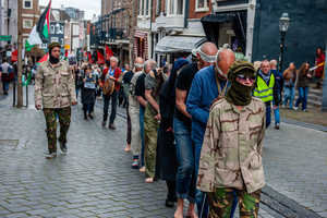 Activists on the streets are observing the silent procession passing by. Activists performed as the Palestinian hostages held by the Israel government during a silent procession through the city to demand their release and against Israel's new execution law. With this protest, Nijmegen for Palestine wants to draw attention to the Palestinian hostages, who are often held for months, even years, without charge in appalling Israeli detention camps.