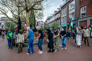 An activist performs as an Israeli soldier is disturbing the "Palestinian hostages". Activists performed as the Palestinian hostages held by the Israel government during a silent procession through the city to demand their release and against Israel's new execution law. With this protest, Nijmegen for Palestine wants to draw attention to the Palestinian hostages, who are often held for months, even years, without charge in appalling Israeli detention camps.