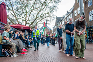 People on the terraces are seen watching the pro-Palestinian activists passing by. Activists performed as the Palestinian hostages held by the Israel government during a silent procession through the city to demand their release and against Israel's new execution law. With this protest, Nijmegen for Palestine wants to draw attention to the Palestinian hostages, who are often held for months, even years, without charge in appalling Israeli detention camps.