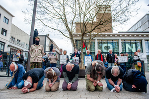 A view of the "Palestinian hostages" performing in the middle of the square. Activists performed as the Palestinian hostages held by the Israel government during a silent procession through the city to demand their release and against Israel's new execution law. With this protest, Nijmegen for Palestine wants to draw attention to the Palestinian hostages, who are often held for months, even years, without charge in appalling Israeli detention camps.