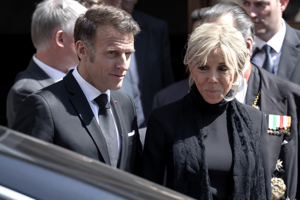 French President Emmanuel Macron and his wife Brigitte Macron leave the St. Damasus Courtyard at the end of their meeting with Pope Leo XIV in the Vatican.