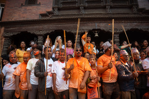 Nepalese devotees carry the traditional sticks during the Festival. Sindoor Jatra or vermillion powder festival is celebrated each year to welcome the start of spring and Nepalese New Year, by playing a traditional instrument, singing, dancing, and carrying chariots of several gods and goddesses around the place.