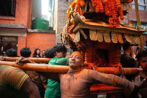 Nepalese devotees carry the chariot during the Festival. Sindoor Jatra or vermillion powder festival is celebrated each year to welcome the start of spring and Nepalese New Year, by playing a traditional instrument, singing, dancing, and carrying chariots of several gods and goddesses around the place.