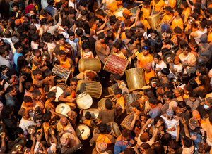 Nepalese devotees playing traditional musical instruments during the Festival. Sindoor Jatra or vermillion powder festival is celebrated each year to welcome the start of spring and Nepalese New Year, by playing a traditional instrument, singing, dancing, and carrying chariots of several gods and goddesses around the place.