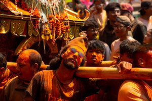 Nepalese devotees carry the chariot during the Festival. Sindoor Jatra or vermillion powder festival is celebrated each year to welcome the start of spring and Nepalese New Year, by playing a traditional instrument, singing, dancing, and carrying chariots of several gods and goddesses around the place.