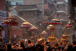 Nepalese devotees carry the chariot during the Festival. Sindoor Jatra or vermillion powder festival is celebrated each year to welcome the start of spring and Nepalese New Year, by playing a traditional instrument, singing, dancing, and carrying chariots of several gods and goddesses around the place.