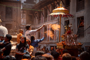 Revelers sprinkle the vermilion powder on a chariot during the Festival. Sindoor Jatra or vermillion powder festival is celebrated each year to welcome the start of spring and Nepalese New Year, by playing a traditional instrument, singing, dancing, and carrying chariots of several gods and goddesses around the place.