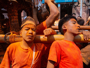 Nepalese devotees carry the chariot during the Festival. Sindoor Jatra or vermillion powder festival is celebrated each year to welcome the start of spring and Nepalese New Year, by playing a traditional instrument, singing, dancing, and carrying chariots of several gods and goddesses around the place.