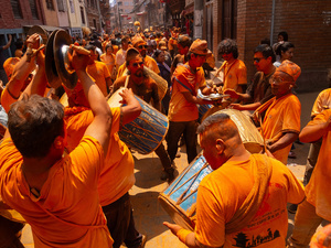 Nepalese devotees playing traditional musical instruments during the Festival. Sindoor Jatra or vermillion powder festival is celebrated each year to welcome the start of spring and Nepalese New Year, by playing a traditional instrument, singing, dancing, and carrying chariots of several gods and goddesses around the place.