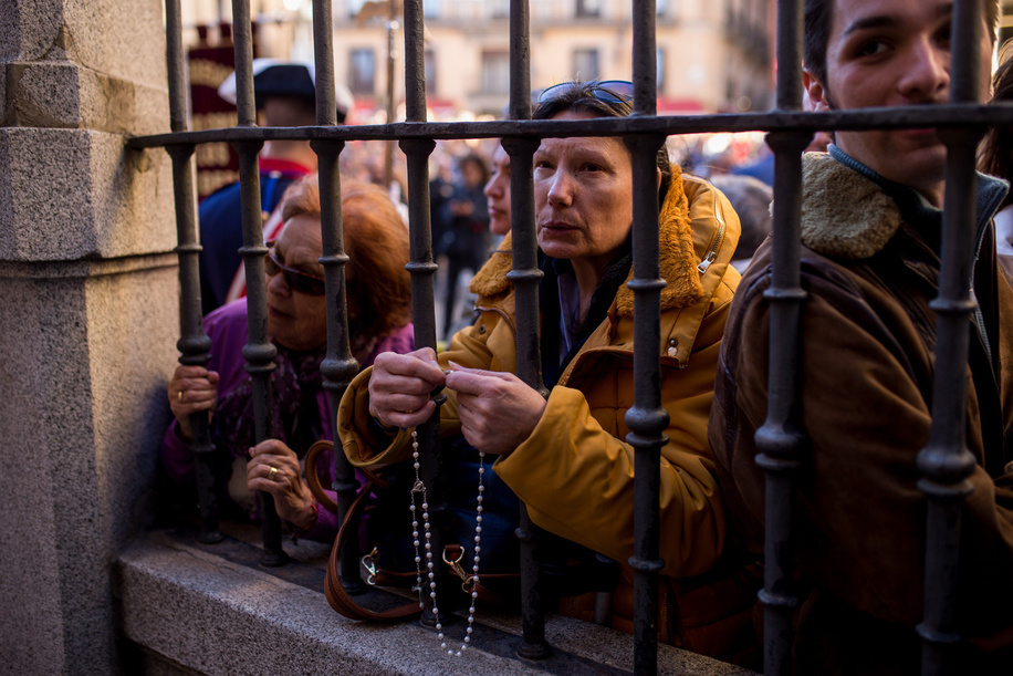 A parishioner prays with a rosary in her hands outside the church during the transfer of the image of Christ of the Halberdiers to the Royal Palace, for preparations for the procession that will take place through the streets of Madrid next Good Friday. Organized by the Congregation of the Holy Christ of Faith, Christ of the Halberdiers and Mary Immaculate Queen of the Angels.