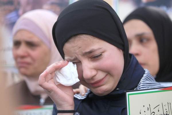 A Palestinian girl cries during a protest in Balata refugee camp, east of Nablus in the West Bank, demanding the release of Palestinians detained in Israeli prisons. The number of Palestinians detained in Israeli prisons has reached over 9,500, including 3,405 administrative detainees, 350 children, and 26 women.