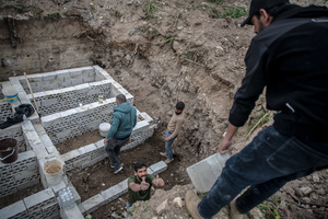 Men prepare graves in a cemetery in the village of Majdal Zoun, Tyre district. After a 10-day ceasefire declared on April 16, 2026, displaced families in Lebanon began returning to assess widespread destruction from weeks of fighting that killed over 2,400 people. Many homes, hospitals, and key infrastructure were damaged, while more than one million people remain displaced. Despite the pause, access to some areas is restricted, and fears persist that fighting could resume.