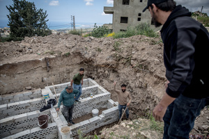 Men prepare graves in a cemetery in the village of Majdal Zoun, Tyre district. After a 10-day ceasefire declared on April 16, 2026, displaced families in Lebanon began returning to assess widespread destruction from weeks of fighting that killed over 2,400 people. Many homes, hospitals, and key infrastructure were damaged, while more than one million people remain displaced. Despite the pause, access to some areas is restricted, and fears persist that fighting could resume.