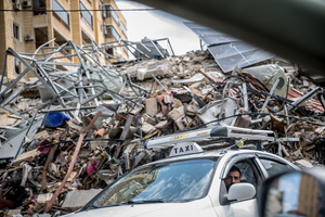 A taxi driver passes a pile of rubble in Beirut’s southern suburbs, known as Dahieyh, during a 10-day ceasefire between Israel and Hezbollah. After a 10-day ceasefire declared on April 16, 2026, displaced families in Lebanon began returning to assess widespread destruction from weeks of fighting that killed over 2,400 people. Many homes, hospitals, and key infrastructure were damaged, while more than one million people remain displaced. Despite the pause, access to some areas is restricted, and fears persist that fighting could resume.