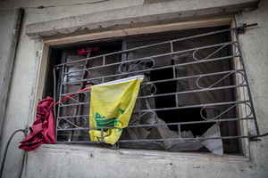 A Hezbollah flag seen in a window in Beirut’s southern suburbs, known as Dahieyh, pictured during a 10-day ceasefire between Israel and Hezbollah. Many displaced people used the opportunity to check on their homes. After a 10-day ceasefire declared on April 16, 2026, displaced families in Lebanon began returning to assess widespread destruction from weeks of fighting that killed over 2,400 people. Many homes, hospitals, and key infrastructure were damaged, while more than one million people remain displaced. Despite the pause, access to some areas is restricted, and fears persist that fighting could resume.