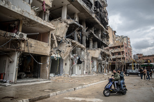 Young men on a motorbike in front of a row of destroyed businesses in Beirut’s southern suburbs, known as Dahieyh, pictured during a 10-day ceasefire between Israel and Hezbollah. Many displaced people used the opportunity to check on their homes. After a 10-day ceasefire declared on April 16, 2026, displaced families in Lebanon began returning to assess widespread destruction from weeks of fighting that killed over 2,400 people. Many homes, hospitals, and key infrastructure were damaged, while more than one million people remain displaced. Despite the pause, access to some areas is restricted, and fears persist that fighting could resume.