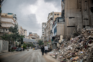 People walk beside rubble in Beirut’s southern suburbs, known as Dahieyh, pictured during a 10-day ceasefire between Israel and Hezbollah. Many displaced people used the opportunity to check on their homes. After a 10-day ceasefire declared on April 16, 2026, displaced families in Lebanon began returning to assess widespread destruction from weeks of fighting that killed over 2,400 people. Many homes, hospitals, and key infrastructure were damaged, while more than one million people remain displaced. Despite the pause, access to some areas is restricted, and fears persist that fighting could resume.