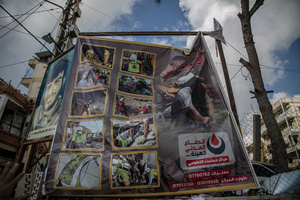A poster commemorates paramedics working for the Hezbollah-linked Islamic Health Authority in Jibchit, southern Lebanon. After a 10-day ceasefire declared on April 16, 2026, displaced families in Lebanon began returning to assess widespread destruction from weeks of fighting that killed over 2,400 people. Many homes, hospitals, and key infrastructure were damaged, while more than one million people remain displaced. Despite the pause, access to some areas is restricted, and fears persist that fighting could resume.