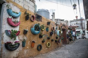 Decorative tires on an empty street in the village of Jibchit, Nabatieh district. After a 10-day ceasefire declared on April 16, 2026, displaced families in Lebanon began returning to assess widespread destruction from weeks of fighting that killed over 2,400 people. Many homes, hospitals, and key infrastructure were damaged, while more than one million people remain displaced. Despite the pause, access to some areas is restricted, and fears persist that fighting could resume.