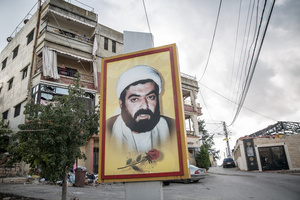 A poster remembering Shia Muslim cleric Ragheb Harb in Jibchit, Nabatieh district. After a 10-day ceasefire declared on April 16, 2026, displaced families in Lebanon began returning to assess widespread destruction from weeks of fighting that killed over 2,400 people. Many homes, hospitals, and key infrastructure were damaged, while more than one million people remain displaced. Despite the pause, access to some areas is restricted, and fears persist that fighting could resume.