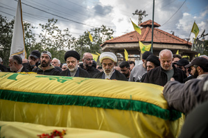 Men pray over coffins during the funeral of three children—Narges, 8; Mohammed, 11; and Zainab, 15—and their mother, Khadija, in Jibchit, Nabatieh district. The family was killed in an Israeli airstrike while displaced. Civilians killed in heavy bombardment were buried in a mass funeral in the village of Jibchit, southern Lebanon. Families returned during a temporary ceasefire to lay victims, many killed in earlier strikes, to rest after being unable to access the cemetery. Mourners carried coffins through the damaged village, reflecting the heavy civilian toll of the conflict.