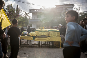 Coffins are seen during the funeral of three children—Narges, 8; Mohammed, 11; and Zainab, 15—and their mother, Khadija, in Jibchit, Nabatieh district. The family was killed in an Israeli airstrike while displaced. Civilians killed in heavy bombardment were buried in a mass funeral in the village of Jibchit, southern Lebanon. Families returned during a temporary ceasefire to lay victims, many killed in earlier strikes, to rest after being unable to access the cemetery. Mourners carried coffins through the damaged village, reflecting the heavy civilian toll of the conflict.