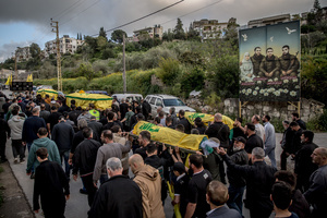 Coffins are carried during the funeral of three children—Narges, 8; Mohammed, 11; and Zainab, 15—and their mother, Khadija, in Jibchit, Nabatieh district. The family was killed in an Israeli airstrike while displaced. Civilians killed in heavy bombardment were buried in a mass funeral in the village of Jibchit, southern Lebanon. Families returned during a temporary ceasefire to lay victims, many killed in earlier strikes, to rest after being unable to access the cemetery. Mourners carried coffins through the damaged village, reflecting the heavy civilian toll of the conflict.