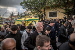 Coffins are carried during the funeral of three children—Narges, 8; Mohammed, 11; and Zainab, 15—and their mother, Khadija, in Jibchit, Nabatieh district. The family was killed in an Israeli airstrike while displaced. Civilians killed in heavy bombardment were buried in a mass funeral in the village of Jibchit, southern Lebanon. Families returned during a temporary ceasefire to lay victims, many killed in earlier strikes, to rest after being unable to access the cemetery. Mourners carried coffins through the damaged village, reflecting the heavy civilian toll of the conflict.