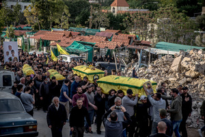 Coffins are carried during the funeral of three children—Narges, 8; Mohammed, 11; and Zainab, 15—and their mother, Khadija, in Jibchit, Nabatieh district. The family was killed in an Israeli airstrike while displaced. Civilians killed in heavy bombardment were buried in a mass funeral in the village of Jibchit, southern Lebanon. Families returned during a temporary ceasefire to lay victims, many killed in earlier strikes, to rest after being unable to access the cemetery. Mourners carried coffins through the damaged village, reflecting the heavy civilian toll of the conflict.