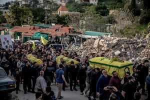 Coffins are carried during the funeral of three children—Narges, 8; Mohammed, 11; and Zainab, 15—and their mother, Khadija, in Jibchit, Nabatieh district. The family was killed in an Israeli airstrike while displaced. Civilians killed in heavy bombardment were buried in a mass funeral in the village of Jibchit, southern Lebanon. Families returned during a temporary ceasefire to lay victims, many killed in earlier strikes, to rest after being unable to access the cemetery. Mourners carried coffins through the damaged village, reflecting the heavy civilian toll of the conflict.